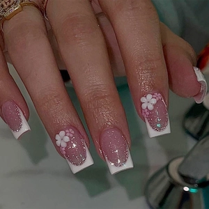 French tip press-on nails with pink glitter base and 3D floral accents in square shape