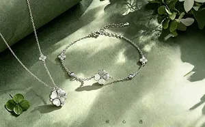 Macro detail of 925 silver clover necklace and bracelet with mother-of-pearl inlays