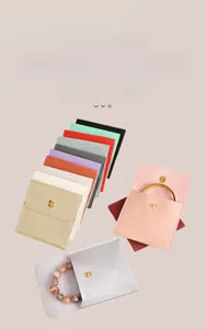 Macro view of macaron-colored jewelry pouches with snap buttons in various soft colors