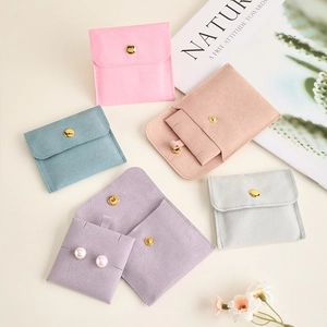 Pastel plush jewelry pouches with gold snap buttons and internal earring cards