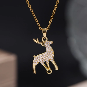 Macro detail of gold pony pendant featuring sparkling white zircon pavé on a fine chain