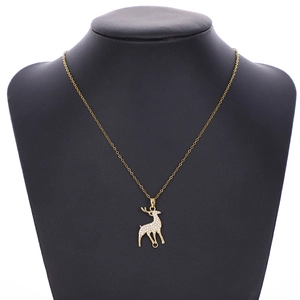 Detailed close-up of a sparkling zircon pony pendant necklace in gold finish on display