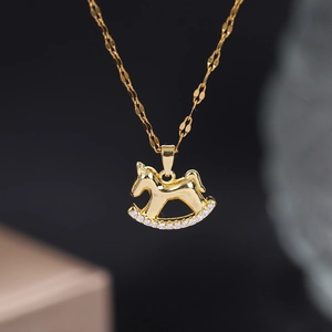 Elegant gold rocking horse pendant necklace with sparkling cubic zirconia on a fine chain