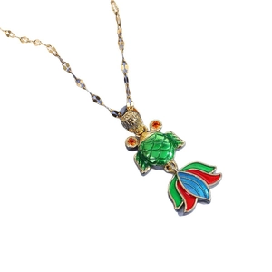 Golden flat-link chain necklace featuring a colorful enamel goldfish pendant with gems