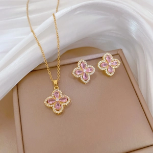 Pink clover jewelry set including necklace and earrings in gold-plated finish