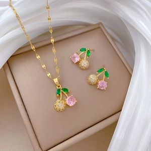 Elegant gold cherry jewelry set with pink zircons including necklace and earrings