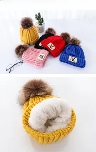 Detailed view of the thick white fleece lining inside children's knitted winter hat