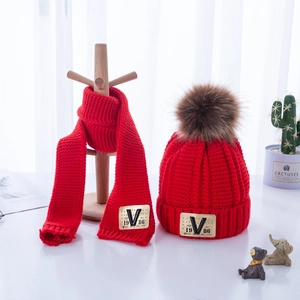 Kids red knit hat and scarf set with brown faux fur pom pom and leather V-patch