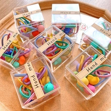Detail of colorful high-elastic hair tie sets in clear gift boxes with handmade labels