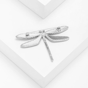 Silver dragonfly brooch with abalone shell details shown from the back with secure pin