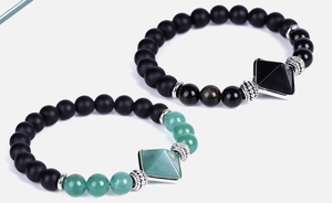 Detail of matte black onyx beads and pyramid charms on bohemian elastic bracelets