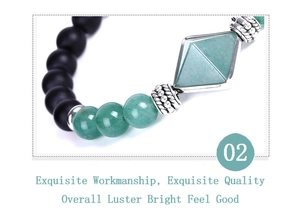 Detail of matte black onyx beads and green gemstone set in silver frame on bracelet