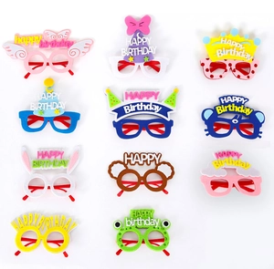 Flat lay of colorful felt birthday party glasses with cartoon ears and wings