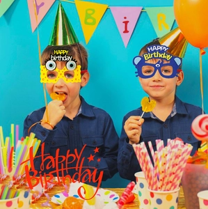 Close-up of colorful cartoon animal party glasses and birthday decorations for children
