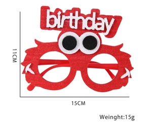 Detail of red felt birthday glasses featuring fuzzy monster design and cutout text