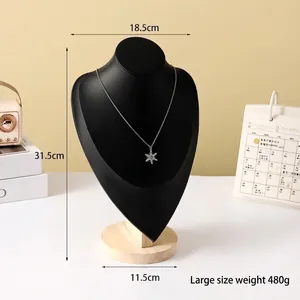 Large matte black mannequin bust display for necklaces featuring a silver snowflake pendant