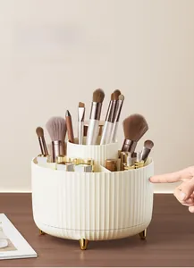 Detail of rotating makeup brush organizer with vertical stripes and gold support feet