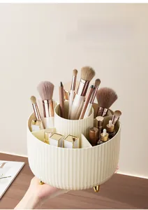 Creamy rotating cosmetics organizer with vertical stripes and golden legs