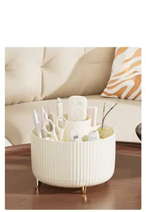 Detail of cream white rotating makeup brush organizer with gold legs and vertical texture