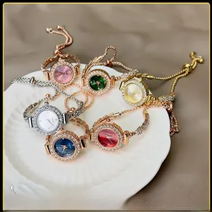 Detailed display of rhinestone bezel quartz watches with adjustable link bracelets in multiple colors