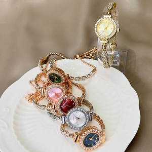Detailed view of women's quartz watch collection with sparkling crystal bezel and chain strap