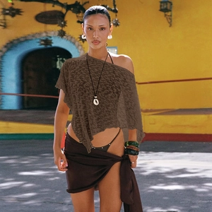 Close-up of asymmetrical sheer knit cover-up in coffee brown with hollow mesh texture
