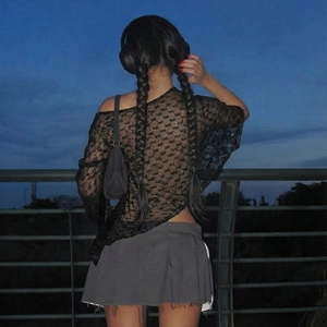 Detailed back view of a sheer black lace off-shoulder top with intricate floral patterns
