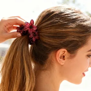 Elegant burgundy flower hair claw clip for women shown on a ponytail in outdoor lighting