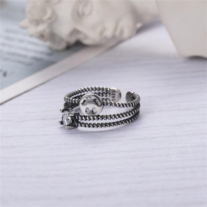 Detailed macro view of S925 sterling silver triple-layer rope ring with zircon and smile charm