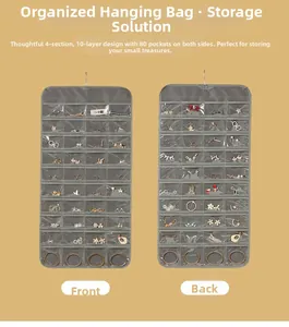 Detail of 80 transparent PVC pockets on a double-sided gray jewelry organizer hanging bag
