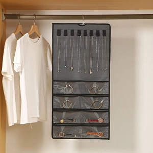 Hanging jewelry organizer with 8 necklace hooks and 8 clear PVC pockets in dark grey