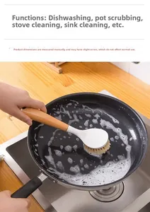 Detail of long wooden handle kitchen brush scrubbing a pan with soap foam and dense bristles