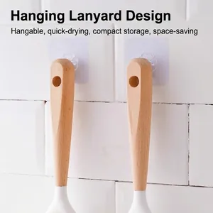 Kitchen dish brush with natural wood handle and convenient hanging hole on tile wall