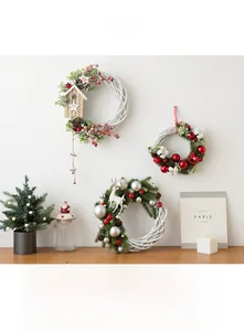Three-piece set of white wicker Christmas wreaths with reindeer, berries, and ornaments
