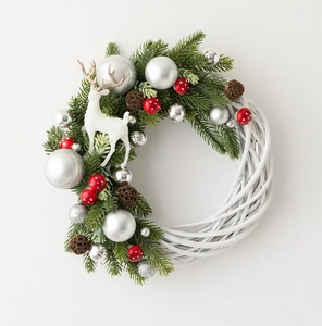 Macro detail of Christmas wreath with white willow base, pine needles and white reindeer