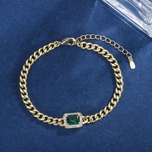 Elegant gold chain bracelet with rectangular emerald gemstone and sparkling halo accents