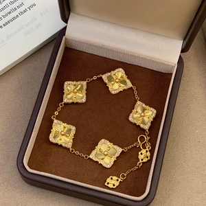 Luxury 24K gold plated clover bracelet with laser texture and shimmering crystal border