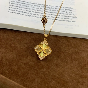 24K gold plated four leaf clover necklace with radial texture and pave diamonds