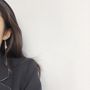 Detail shot of long S925 sterling silver chain earrings with irregular curved metal charms