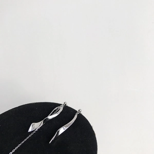 Close-up of S925 sterling silver stamp on asymmetrical twisted long drop earrings