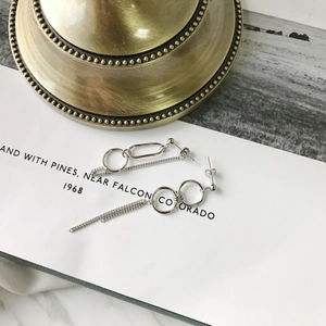 Close-up of S925 sterling silver asymmetrical hoop earrings with long tassel chains