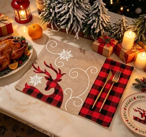 Close-up of burlap Christmas placemat featuring a buffalo plaid reindeer and snowflake pattern