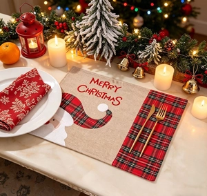 Christmas burlap placemat featuring Santa Claus motif with festive gold cutlery setting