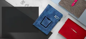 Close-up of business notebook textures showing blue fabric, red metal buckle and grey strap