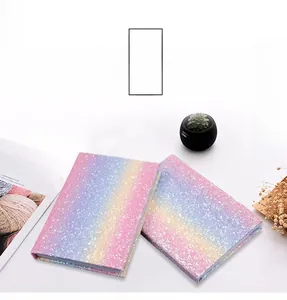 Close-up of glitter rainbow gradient notebooks with sparkling pink and blue finish