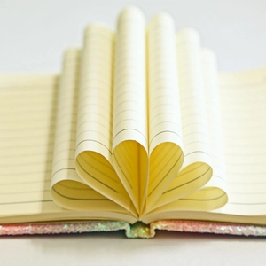 Rainbow glitter cover notebook with cream lined paper in a creative heart-shaped fold