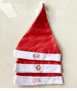 Detailed top view of custom Santa hats with logo printing on soft red non-woven fabric