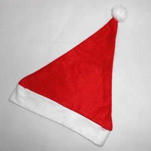 Close-up of red Christmas hat with white plush trim and pom-pom on white mesh