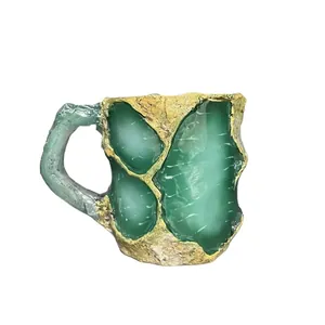Faux mineral crystal coffee mug with green resin stone texture and gold rocky patterns