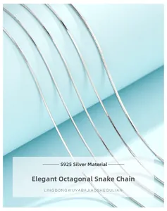 Macro shot of multiple S925 sterling silver octagonal snake bone chains on blue background